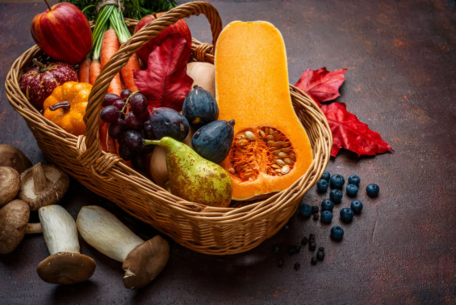 Vibrant fall harvest with squash, fruits, and mushrooms