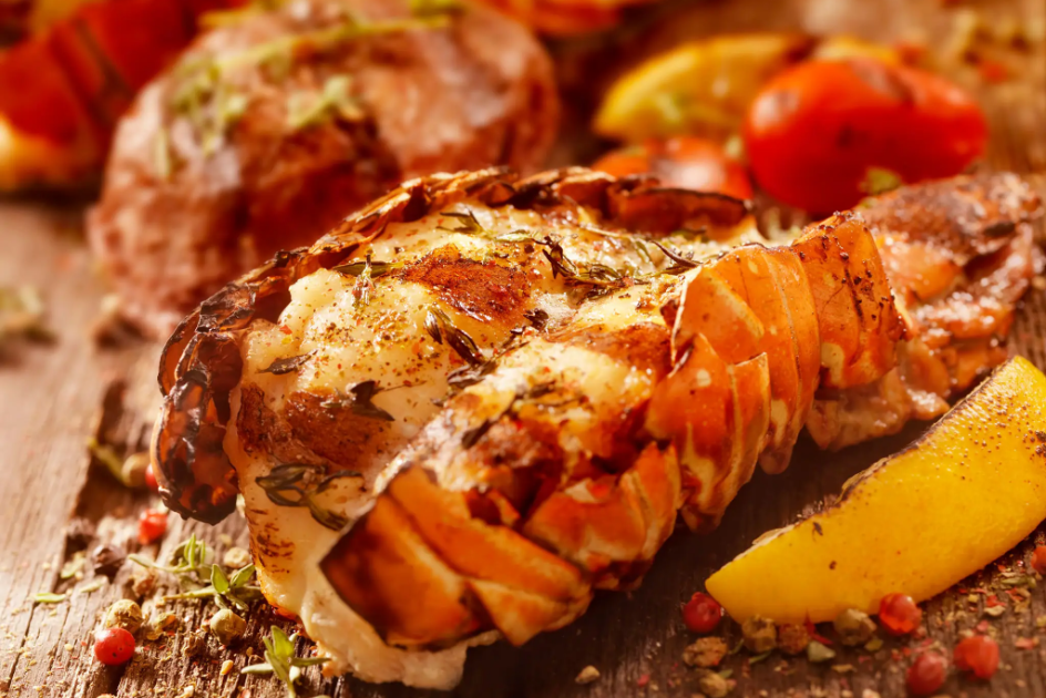Seafood lobster tail with lemon wedge